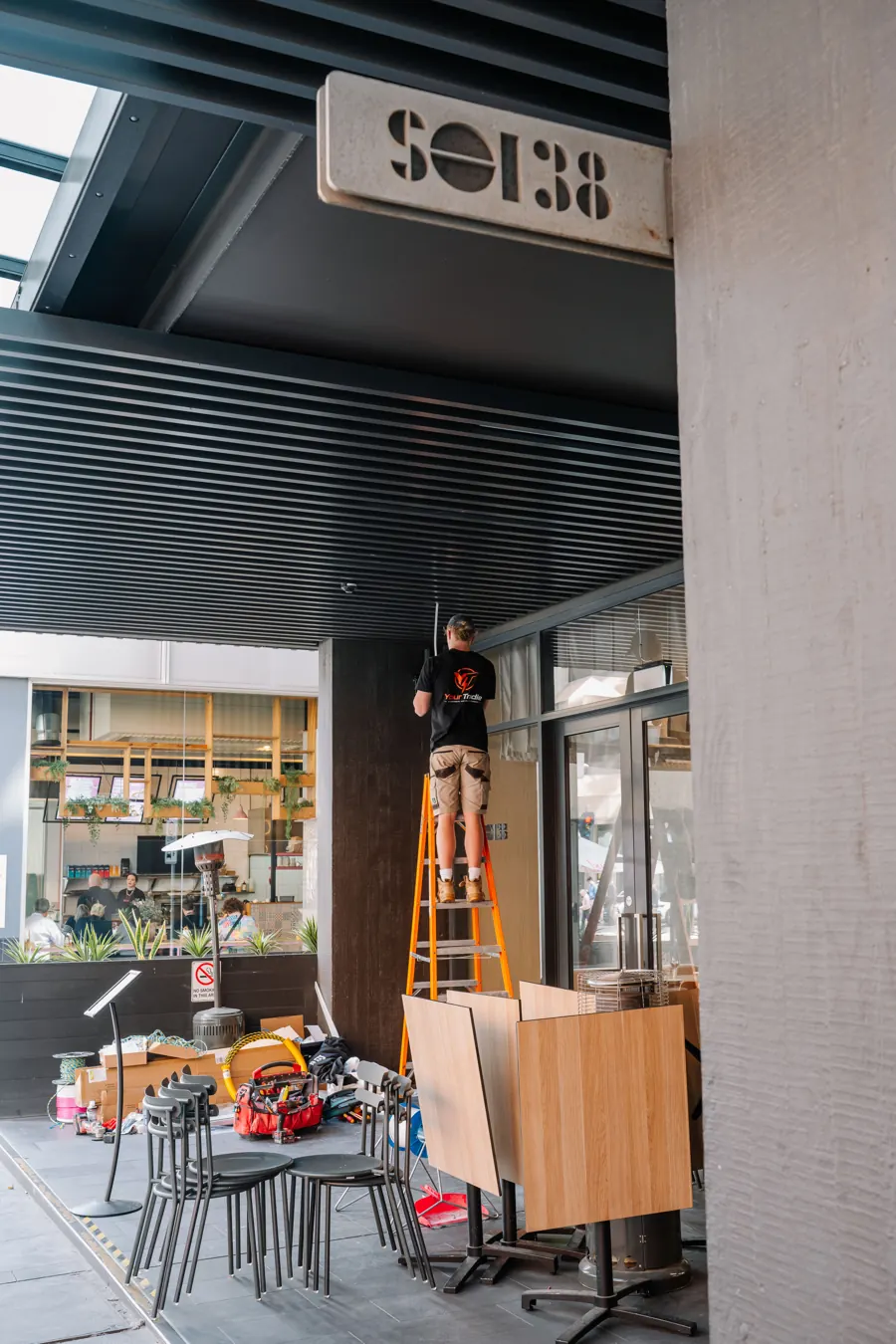 Working up a ladder at the entrance of Soi38